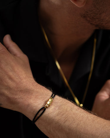 Midnight Lock Zwart Armband Goudkleurig op hand. Handgemaakte sieraden, luxe heren sieraden, premium kwaliteit sieraden.