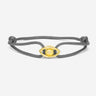 Emerald Guardian Grijs Armband Goudkleurig. Elegante armband met goudkleurig oog en zirconia steen.